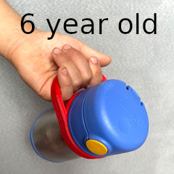 a 6-year-old holding a water bottle by custom handle